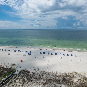 Colorful umbrellas lining the shore, inviting you to relax and soak up the sun
