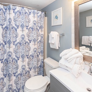 Refresh in this guest bathroom featuring a stylish shower curtain, soft towels, and a modern vanity for your comfort