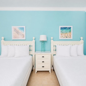 Relax on one of the cozy queen beds in this guest suite and enjoy a peaceful slumber