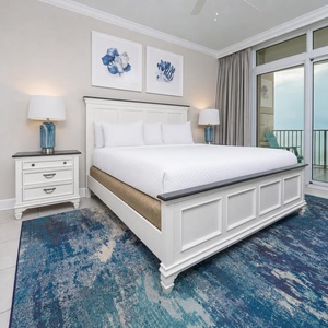 Retreat to the king master suite with cozy bedding and drift off to the sound of the waves from the balcony