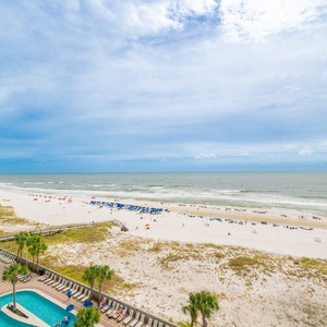 Stunning view of the beach and vibrant umbrellas from the balcony, perfect for a relaxing getaway