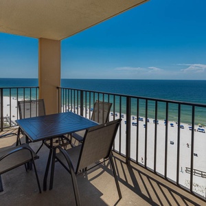 Relax on the balcony with a dining table and chairs, enjoying the beautiful beach view and gentle sea breeze