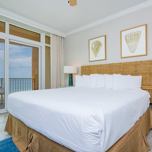 Retreat to the king master suite with cozy bedding and drift off to the sound of the waves from the balcony