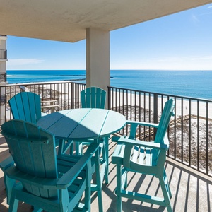 Relax at the turquoise table set on the balcony, enjoying expansive views of the tranquil waters and shoreline