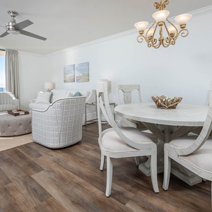 Relax in this airy living space featuring comfortable seating and a dining area, perfect for enjoying meals together