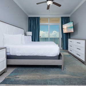 Unwind in this serene master bedroom featuring a king bed, stylish decor, and beachfront balcony access