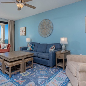 Relax in the cozy living area with colorful decor, sofa with queen sleeper, and easy access to the balcony for fresh gulf air