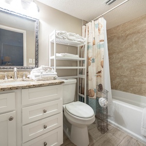 The guest bath features a stylish vanity with granite, a spacious tub/shower combo, and fresh towels for your comfort