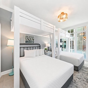 Relax in this charming bunk room with two cozy twins lofted above two plush queen beds
