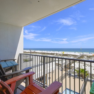 Relax on the colorful chairs of this balcony with a stunning beachfront view, perfect for enjoying the coastal breeze
