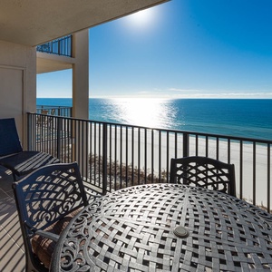 Savor meals at the round table while enjoying the serene beach views and gentle breeze from the balcony