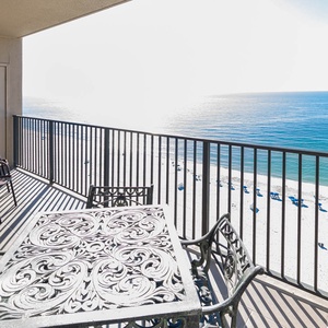 Savor your morning coffee at the outdoor table while taking in the expansive views of the tranquil beach below