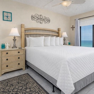 King master suite with stunning beachfront views through large windows, perfect for relaxation