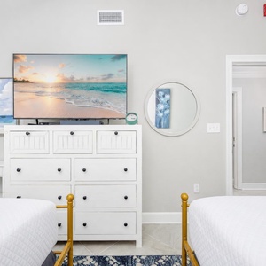 Relax with a movie in this cheerful guest suite with two queen beds and coastal accents