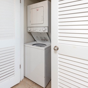 This laundry area features a stacked washer and dryer, providing convenience for guests during their stay