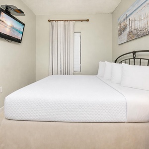 Enjoy a peaceful night in this guest bedroom, enhanced by king bedding and a charming coastal vibe