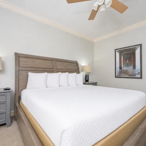 Two bedside lamps cast a soft glow as you sink into the king guest suite's crisp bedding