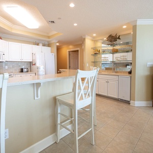 Enjoy morning coffee at the breakfast bar, surrounded by the inviting vibe of your coastal getaway