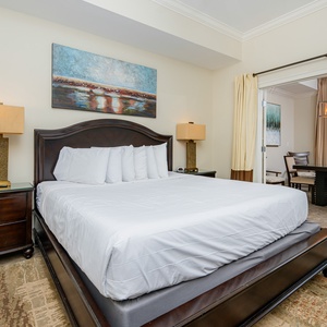 The master bedroom features a king bed, and stylish décor that opens to the dining area with a view of the beach