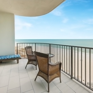 Unwind on the balcony with comfortable seating, perfect for enjoying the tranquil views and gentle gulf breeze