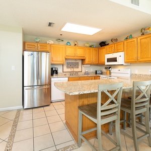 Whip up family favorites at the breakfast bar while chatting and sipping fresh coffee in this kitchen
