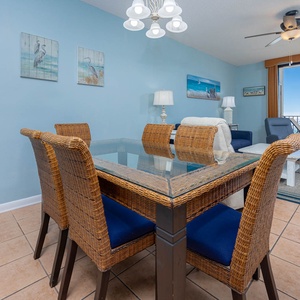 Dine at the glass-top table with wicker chairs, while enjoying views of the shimmering water and inviting decor