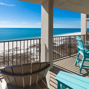 Savor your morning coffee at the turquoise table, soaking in the stunning views and gentle ocean breeze from the balcony