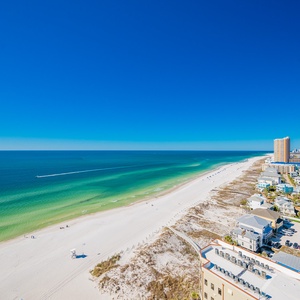 This balcony view showcases the stunning beach with vibrant turquoise waters and soft white sand, perfect for relaxation