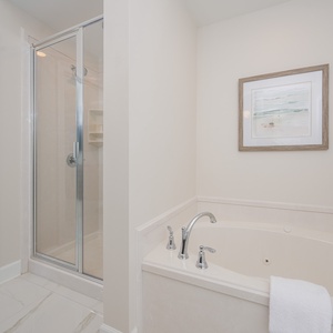 Indulge in relaxation with a spacious jetted tub and a separate walk-in shower, complemented by beach decor