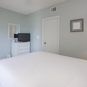 Relax on the cozy queen bed in this guest suite and stream your favorite shows after a beach day