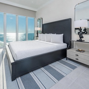 Lie on the soft king bed in the guest suite and watch glittering gulf waters through the wall of glass beside the bed