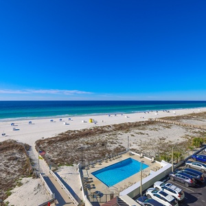 Enjoy stunning beachfront views with a relaxing pool area and easy access to the sandy shore from this inviting space