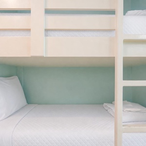 Cozy bunk beds in a cheerful space offer a fun sleeping option for kids, perfect for family vacations