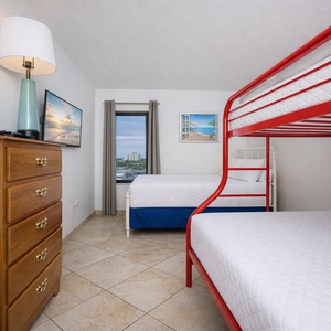 Snuggle up in the bunk room with a twin over full bunk and a twin bed, watching your favorite shows on the TV
