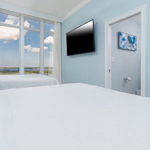 Stretch out on fluffy queen bedding and take in the gulf coast through large windows framed by curtains