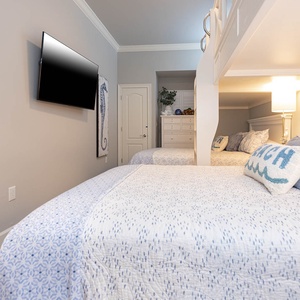 Relax with your favorite shows in this guest bunk room featuring two lofted twins and two queens below