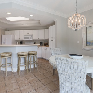 Prepare meals in the kitchen and gather in the dining area to enjoy the coastal art and open design