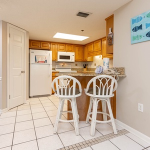 Gather around the breakfast bar with stylish seating, perfect for casual meals and conversations in the kitchen