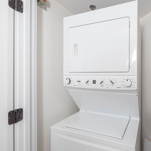 Stacked washer and dryer unit provides convenient laundry options for guests during their stay