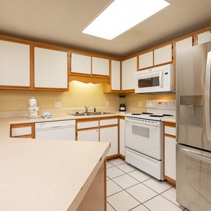 Prepare meals in this functional kitchen featuring ample counter space and a bright atmosphere