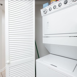 Stacked washer and dryer set tucked away in a closet, providing convenient laundry access during your beach getaway