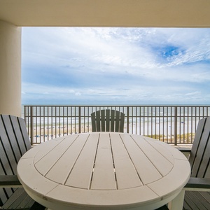 Enjoy the views from the balcony, featuring a round table and comfortable chairs perfect for relaxation