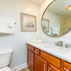 Refresh and rejuvenate in the stylish guest bath, enjoying elegant details that enhance your coastal retreat experience