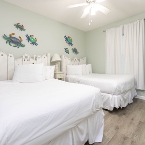 Experience restful nights in this cheerful guest bedroom with two comfortable double beds and playful crab décor