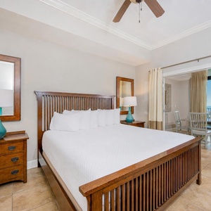 Cozy master bedroom featuring a king bed, elegant decor, and a stunning view through large windows