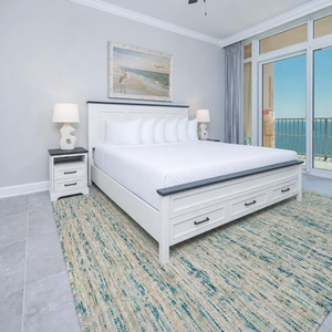 Retreat to the king master suite with cozy bedding and drift off to the sound of the waves from the balcony