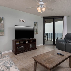 Relax in the inviting living area with comfortable seating and a large TV, perfect for unwinding after a day of fun