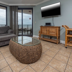 Relax on the plush seating while enjoying the view through large windows and the coastal-inspired decor around you