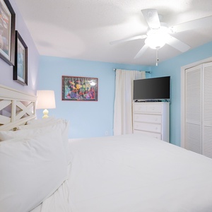 The bedroom features a cozy king bed with a TV and dresser enhancing the inviting atmosphere