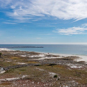 Impressive view of the beach and jetties from the balcony, showcasing white sand and a tranquil atmosphere for relaxation